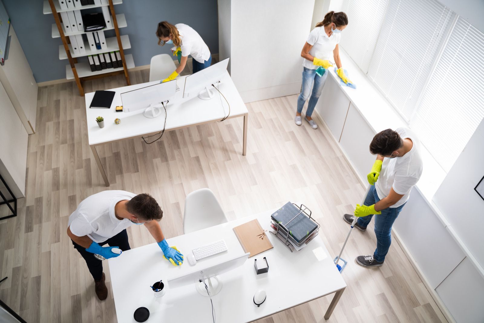 A group of people are cleaning an office.