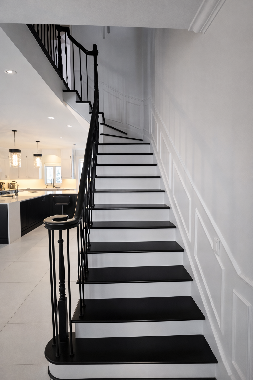 Escalier en noir et blanc dans une maison moderne et lumineuse, vu du bas vers le haut