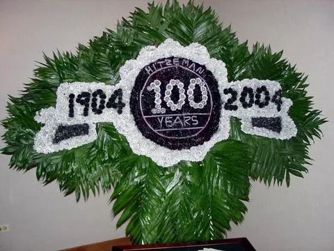 Floral arrangement for 100 year anniversary, with 