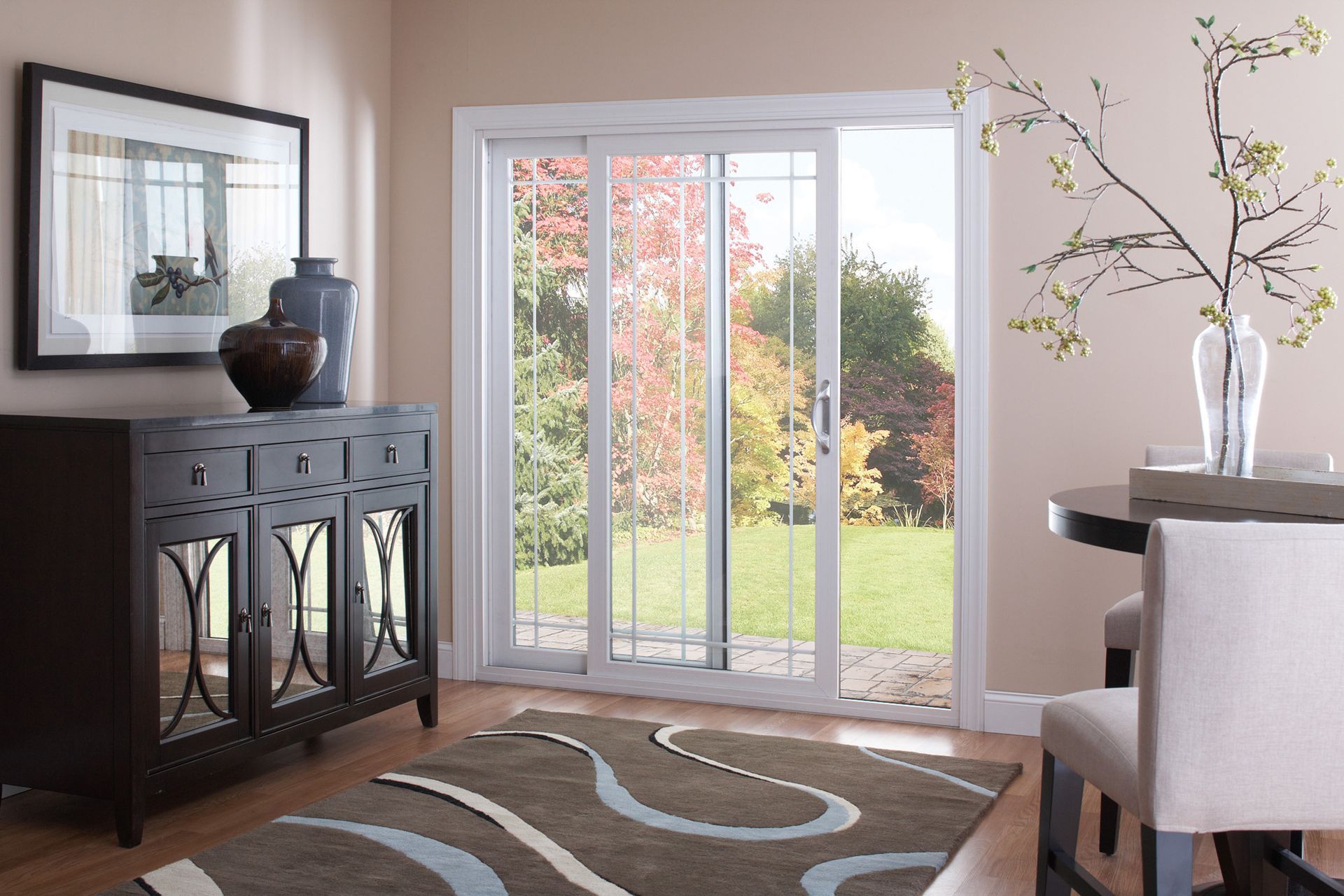 A living room with sliding glass doors and a rug