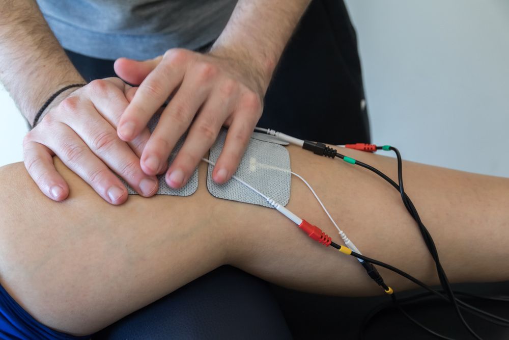 TENS Machine being used on someones leg — Southern Districts Physiotherapy & Sports Injuries Clinic In Albion Park, NSW