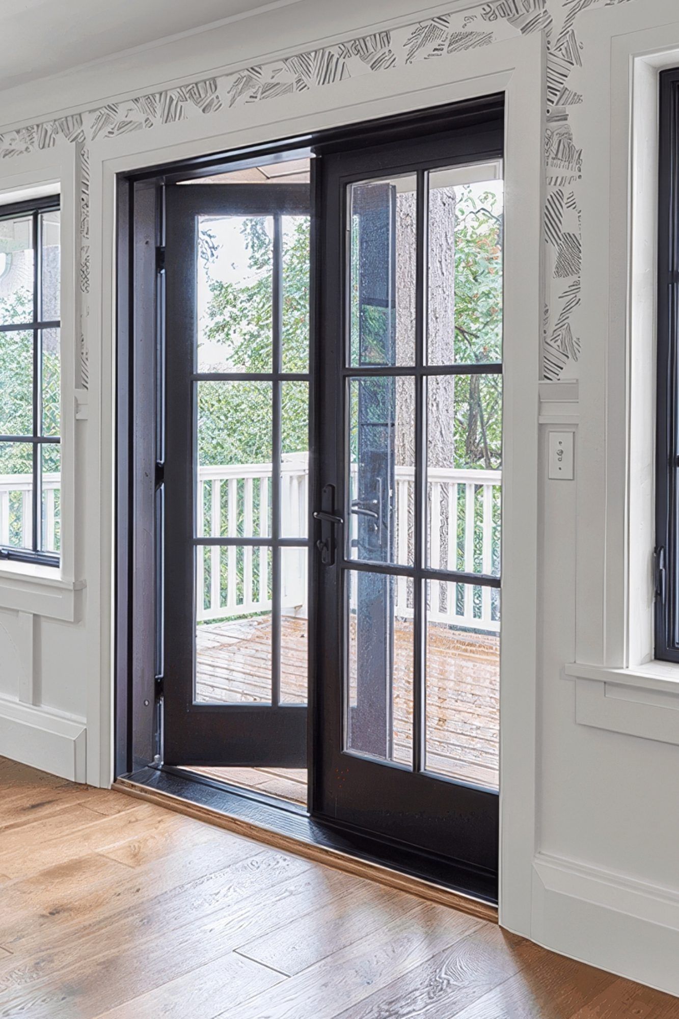 A room with a French glass doors leading to a patio in Doylestown, PA.