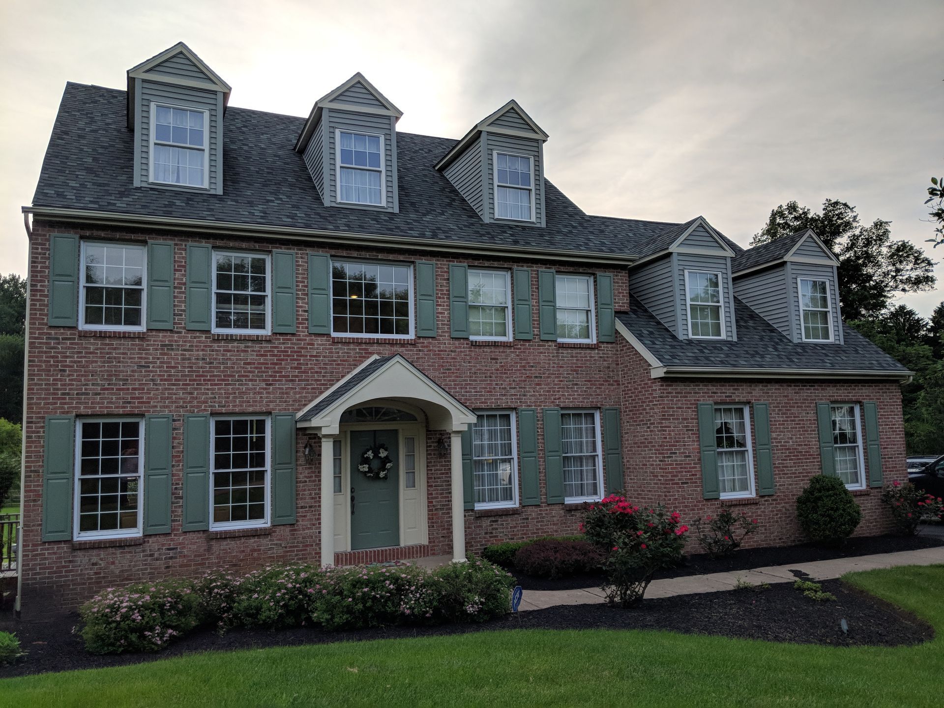 Colonial home with white replacement windows