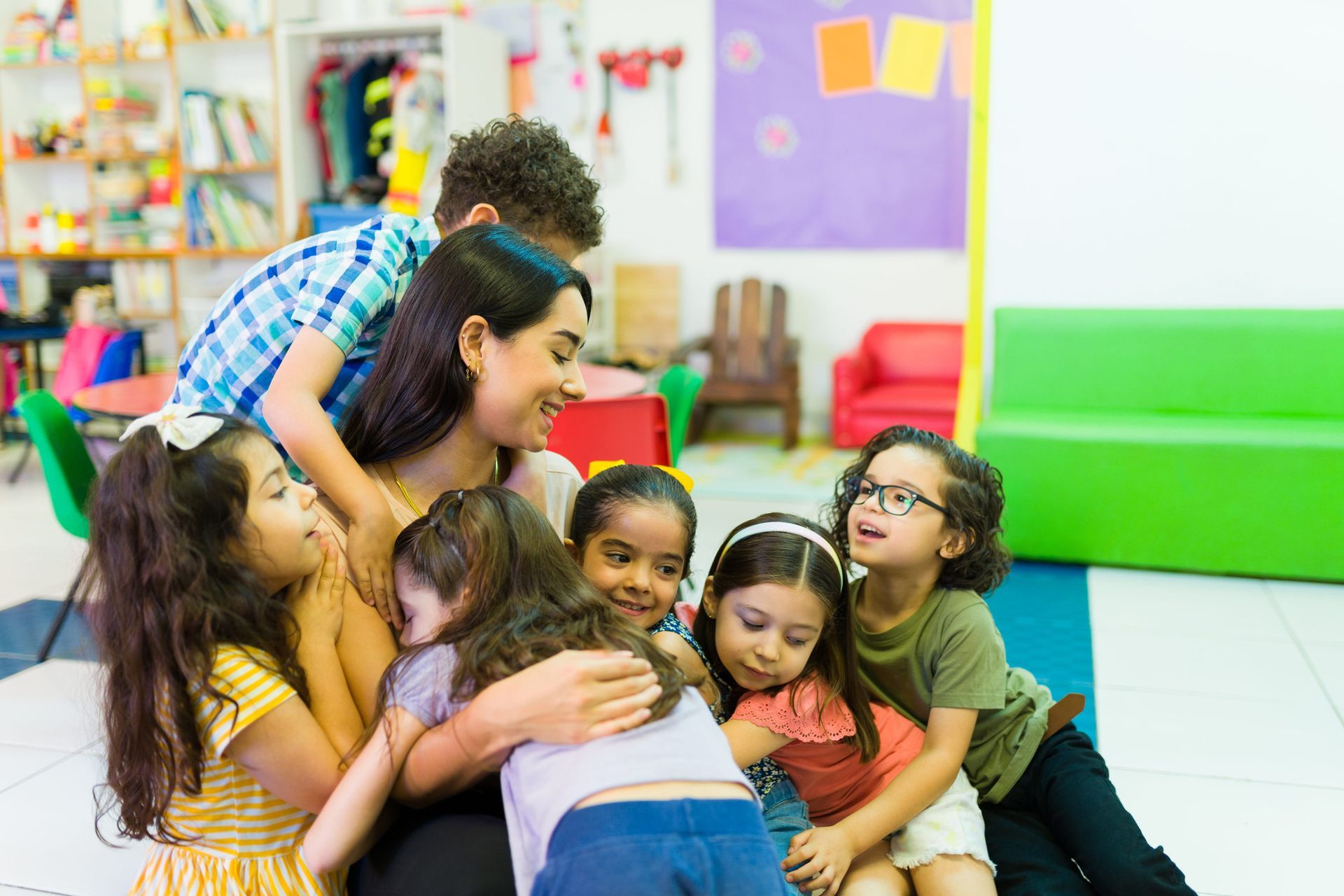 Children and teacher playing and learning in school - Dubai