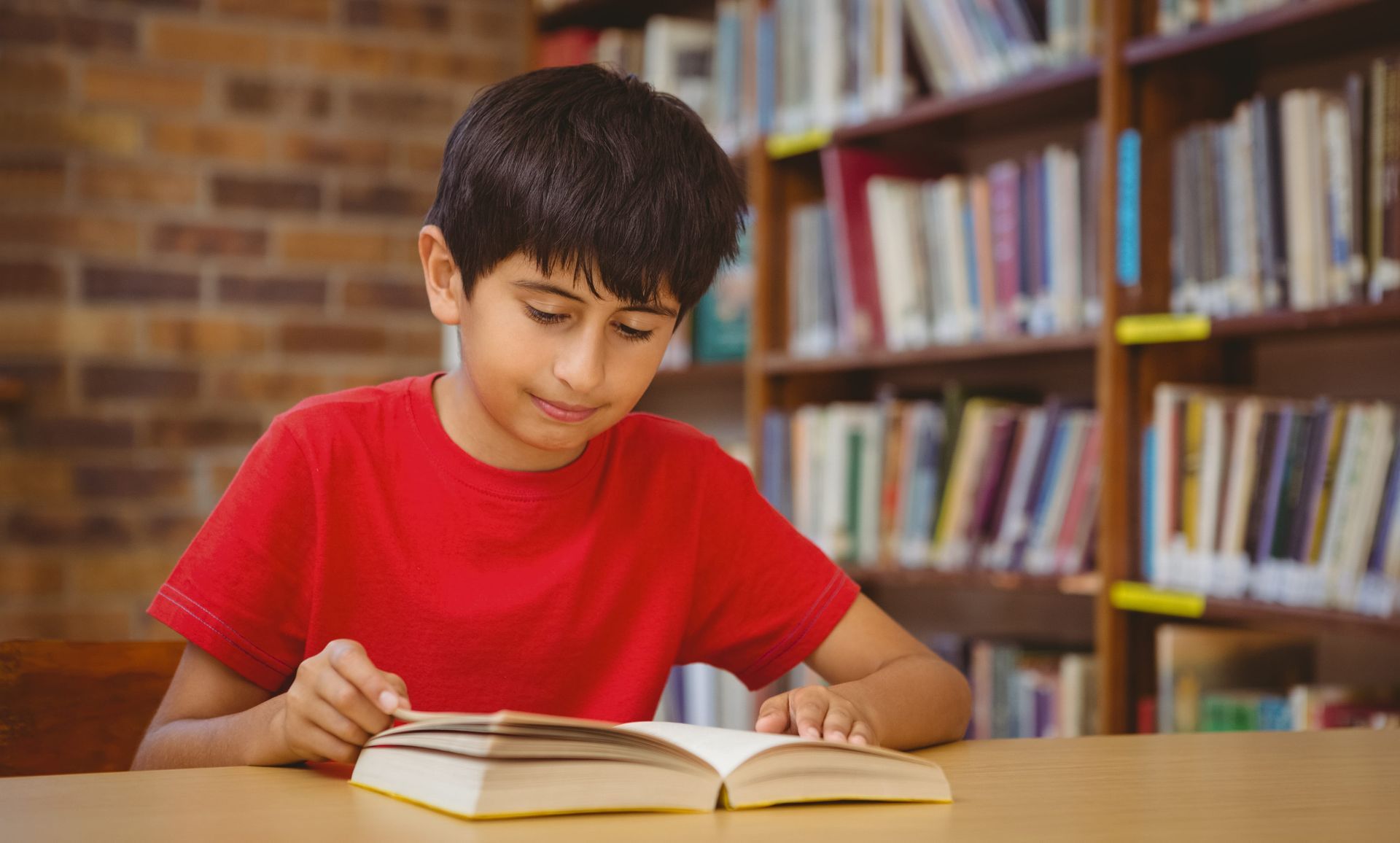 A child reading a book with parent support to improve reading comprehension skills at home.