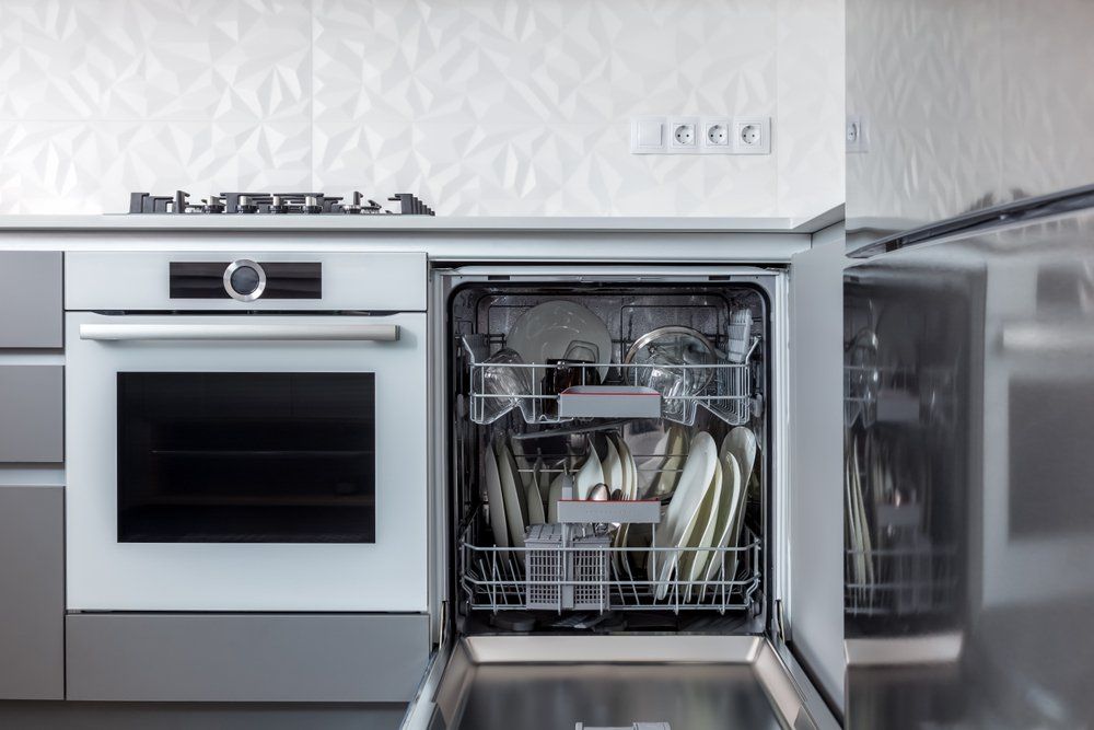 Open Dishwasher With Clean Kitchen Utensils — Elite Appliance Services in Boat Harbour, NSW