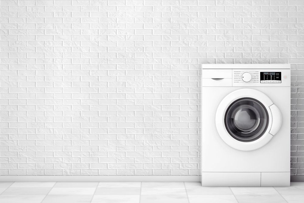Washing Machine In White Brick Background — Elite Appliance Services in Boat Harbour, NSW