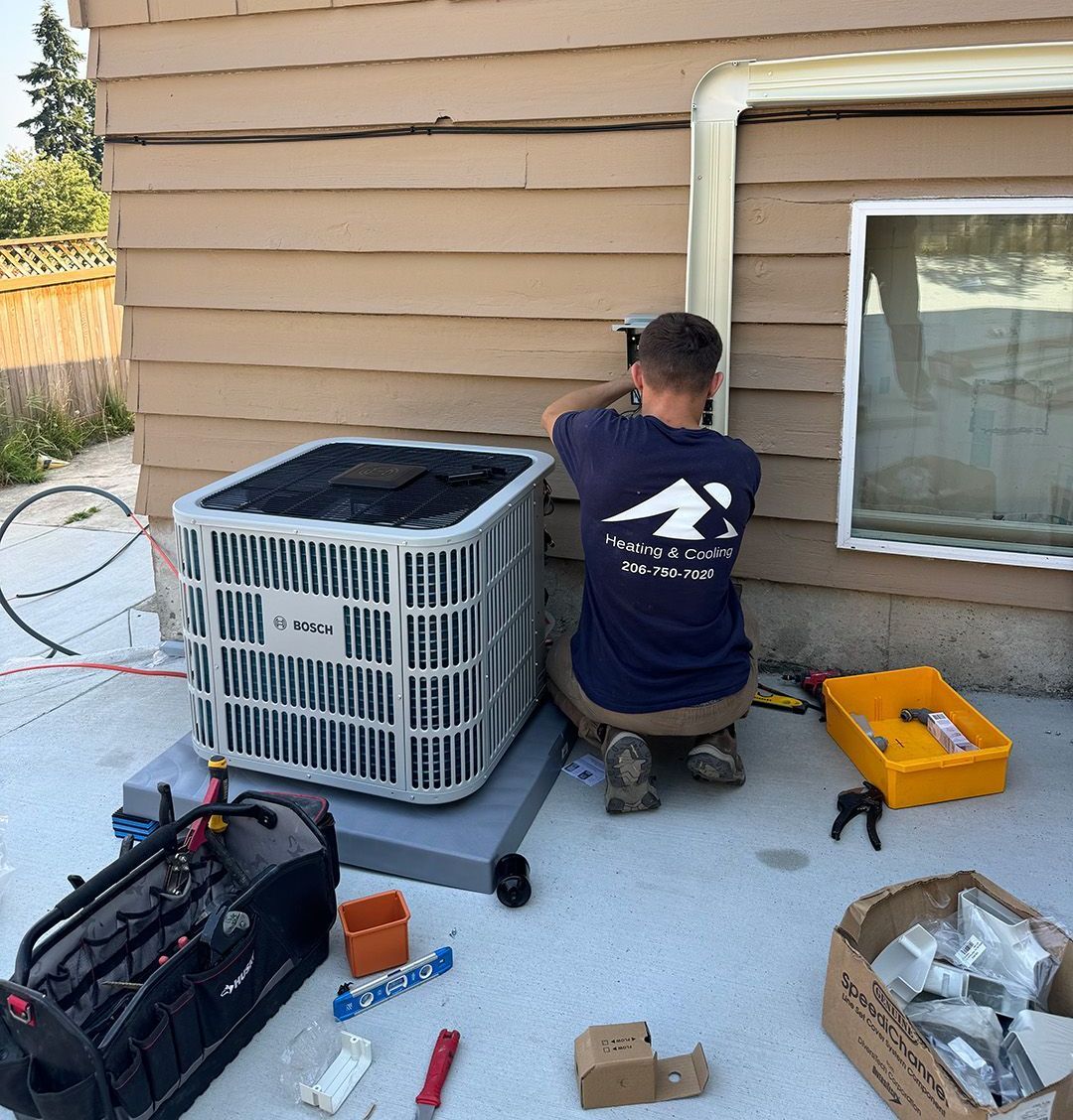 A Ready Energy Solutions Technician in a blue shirt is working on an air conditioner