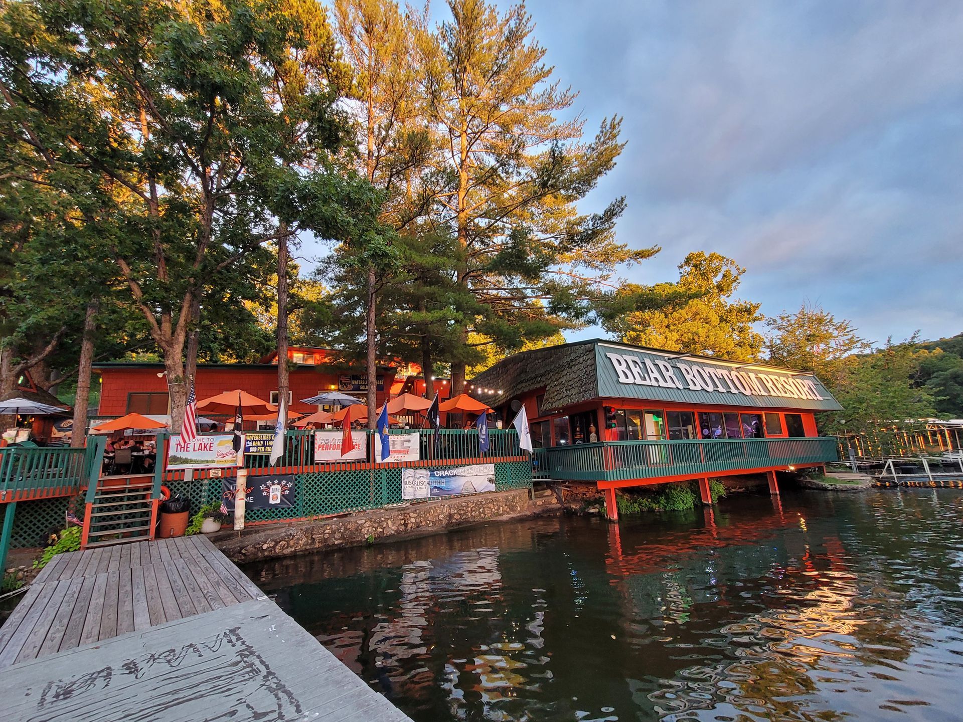 A restaurant is sitting on a dock next to a body of water.