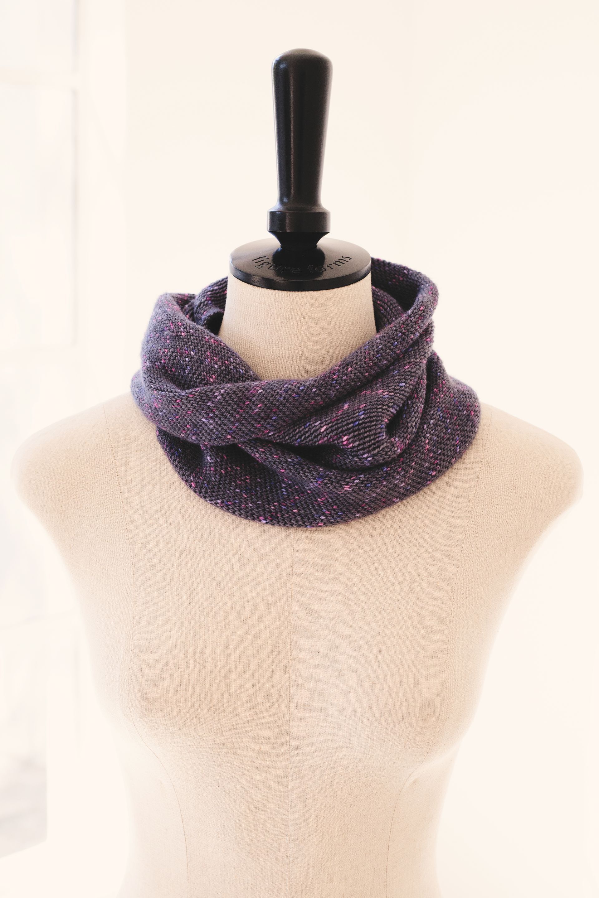 Purple crochet cowl scarf on a mannequin.
