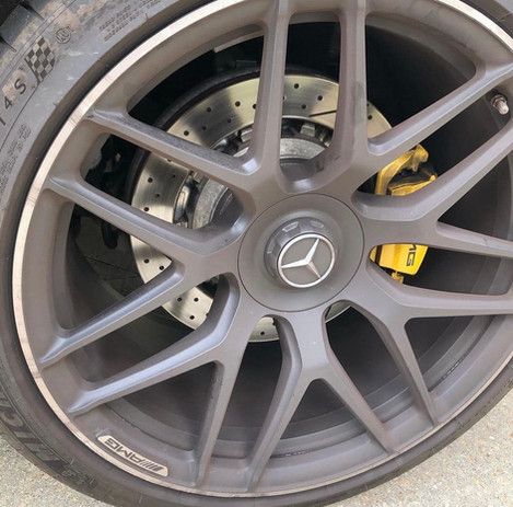 A close up of a car wheel with a mercedes logo on it