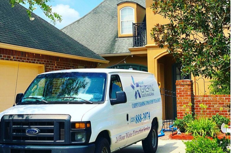 A white van is parked in front of a house.