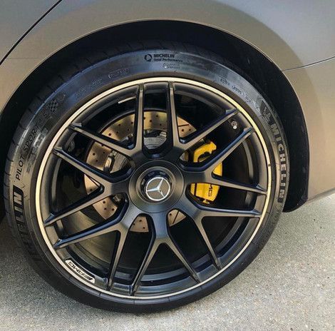 A close up of a car wheel with a tire on it.