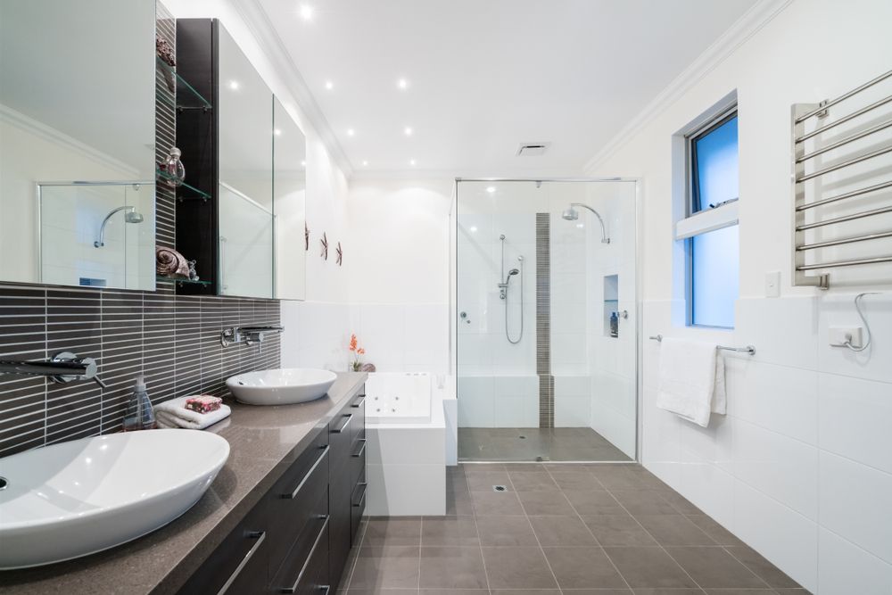 A Bathroom With Two Sinks and a Walk in Shower — Knobel Builders In Dapto, NSW