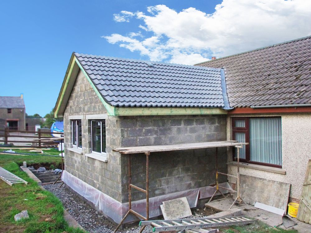 A House is Being Built With Bricks and a Roof — Knobel Builders In Dapto, NSW