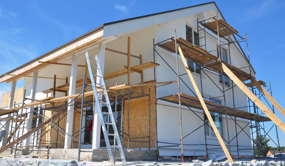A House is Being Built With Scaffolding Around It — Knobel Builders In Austinmer, NSW