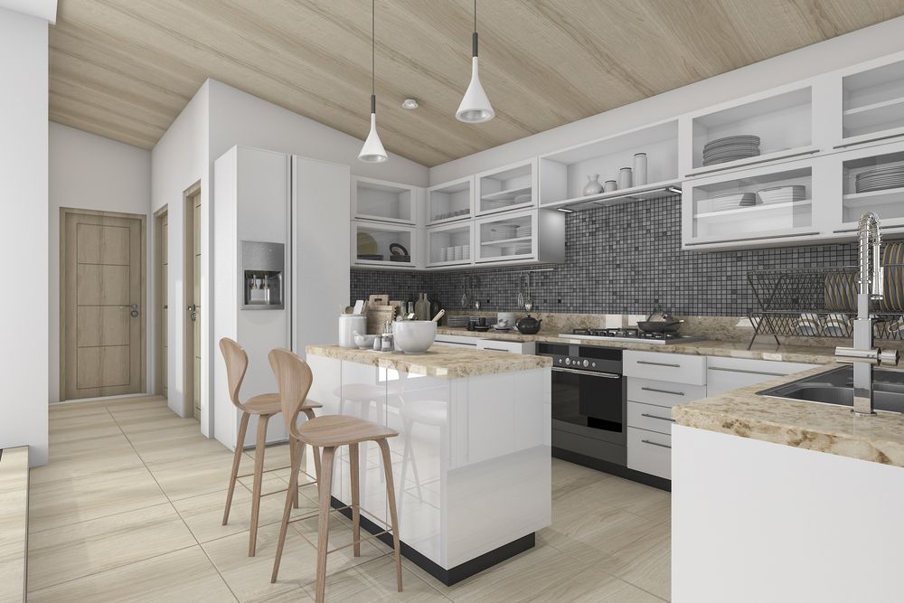 A Modern Kitchen With White Cabinets, Granite Counter Tops, Stainless Steel Appliances and a Large Island — Knobel Builders In Balgownie, NSW