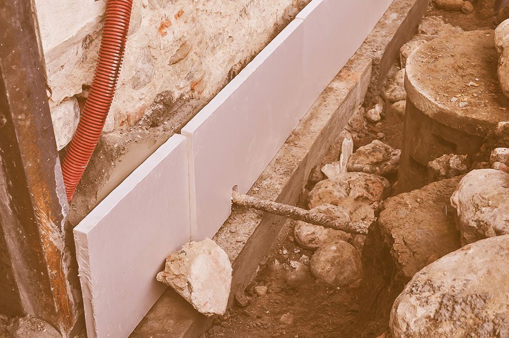 A Piece of Styrofoam is Sitting on the Ground Next to Some Rocks — Knobel Builders In Shellharbour, NSW