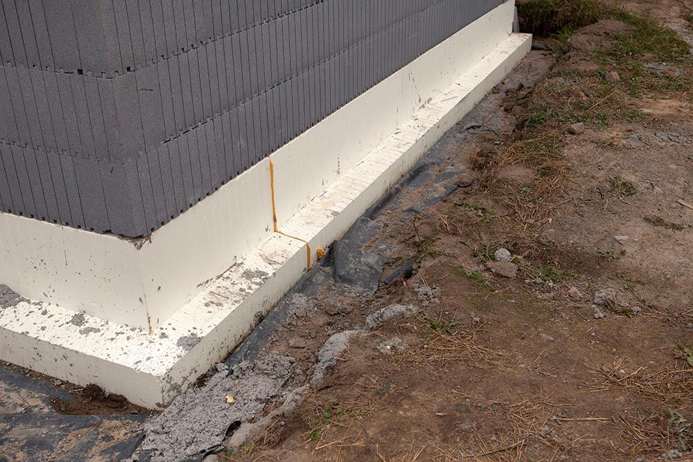A Corner of a Building With a White Foam Barrier on It — Knobel Builders In Shellharbour, NSW