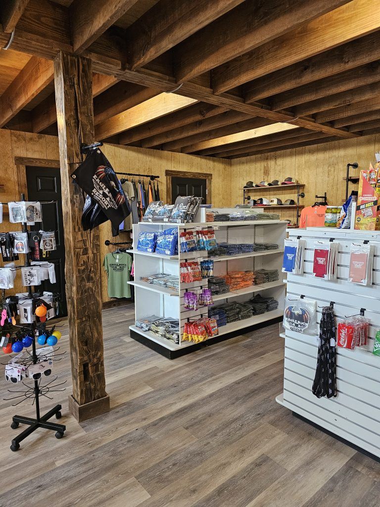 Inside a store with merchandise on shelves and a wood beam.