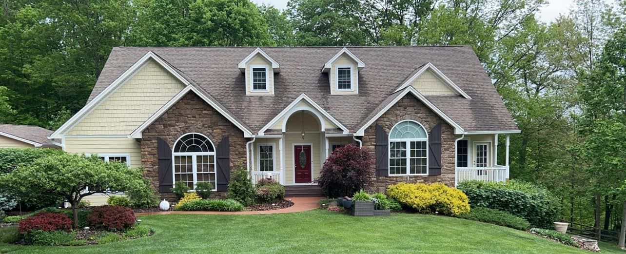 A large house with a lush green lawn in front of it.