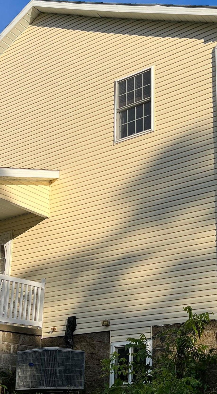 A house with a large window on the side of it.
