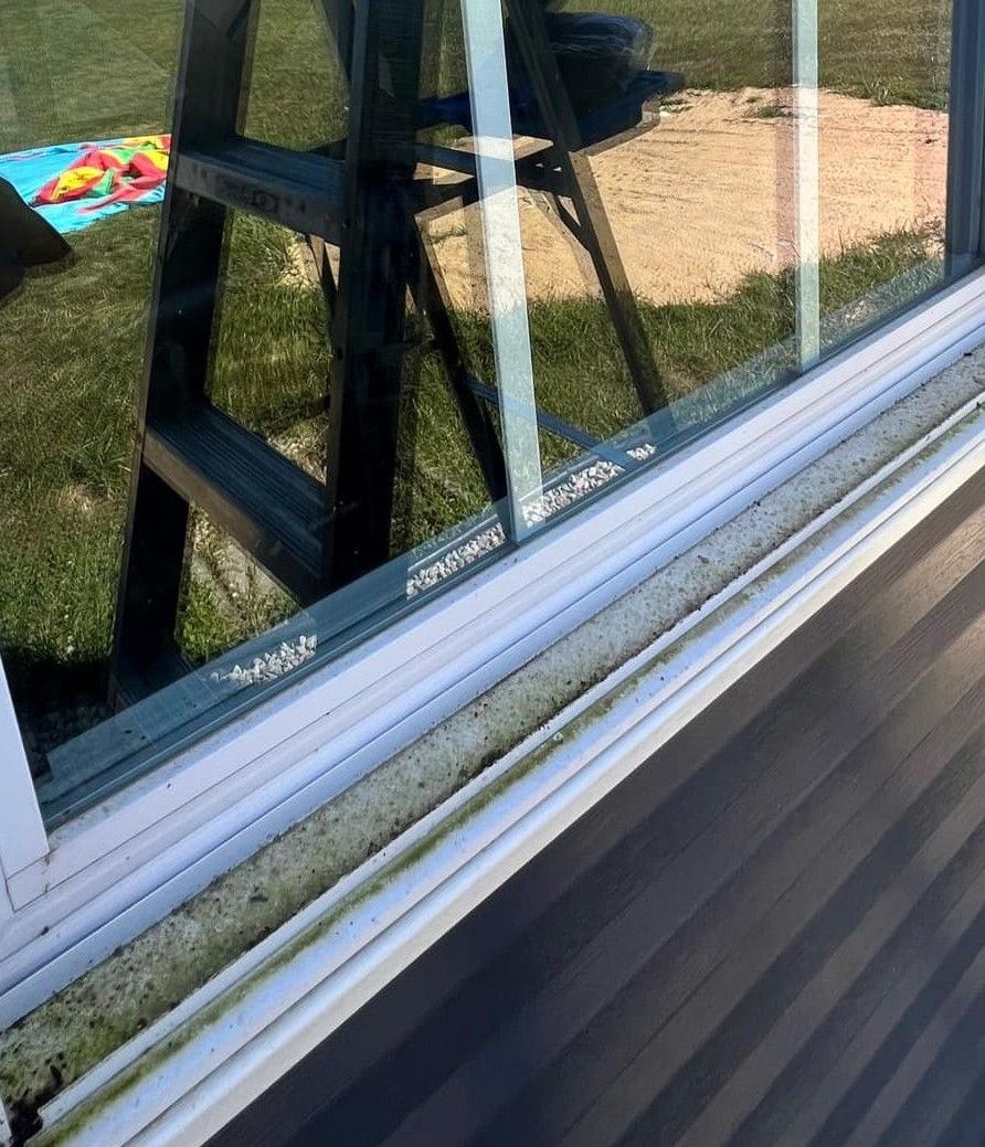 A ladder is reflected in the window of a house.