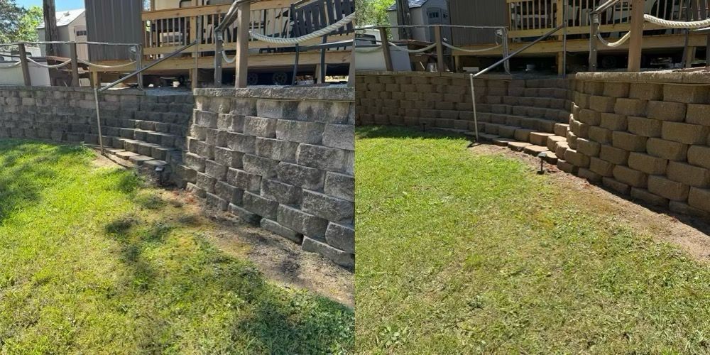 Two retaining walls forming a grassy slope beside a wooden deck in a backyard