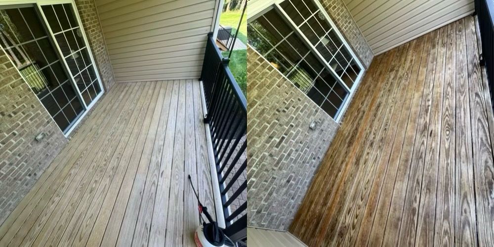 Wooden deck and staircase beside a brick house and screened porch railing