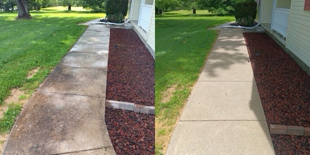 Split view of a concrete walkway before and after cleaning, beside a lawn and house siding.