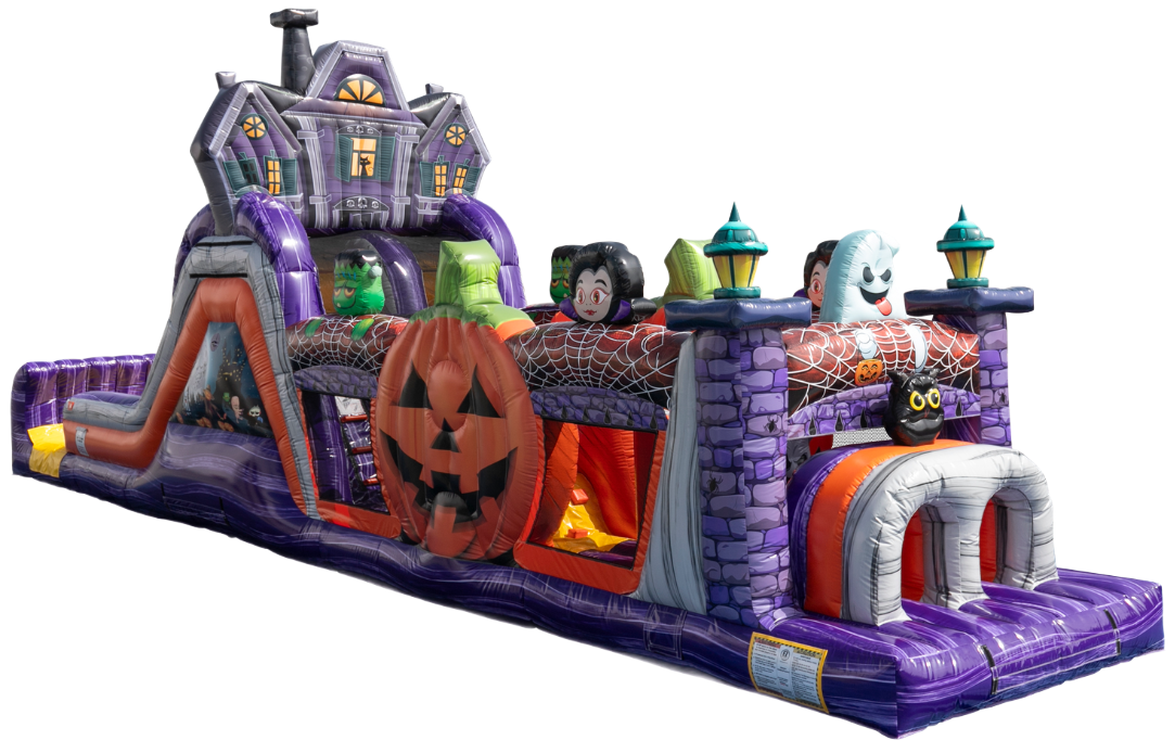Inflatable Halloween-themed obstacle course with a slide, purple brick walls, a large pumpkin, and spooky decorations.