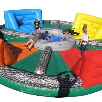 People play a competitive, multi-player inflatable hungry-hungry-hippos style game with colorful partitions and balls.