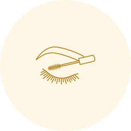 Gold eyelash-and-brow icon on a pale cream circle background