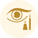 Gold eye makeup icon with an eye, mascara wand, and lipstick on a pale background