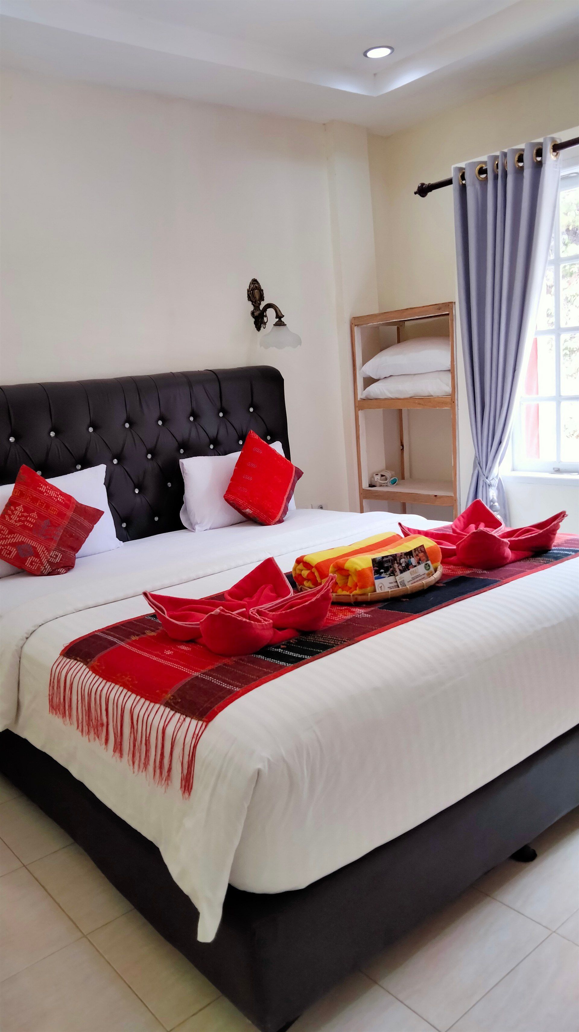 A hotel room with a king size bed and a bunk bed.