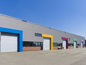A row of colorful buildings with a blue sky in the background