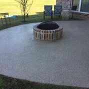 There is a fire pit in the middle of the patio.