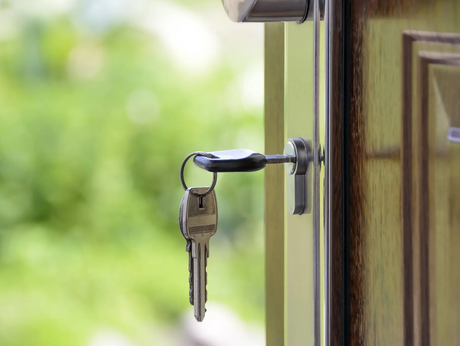 A close up of a key in a door lock.