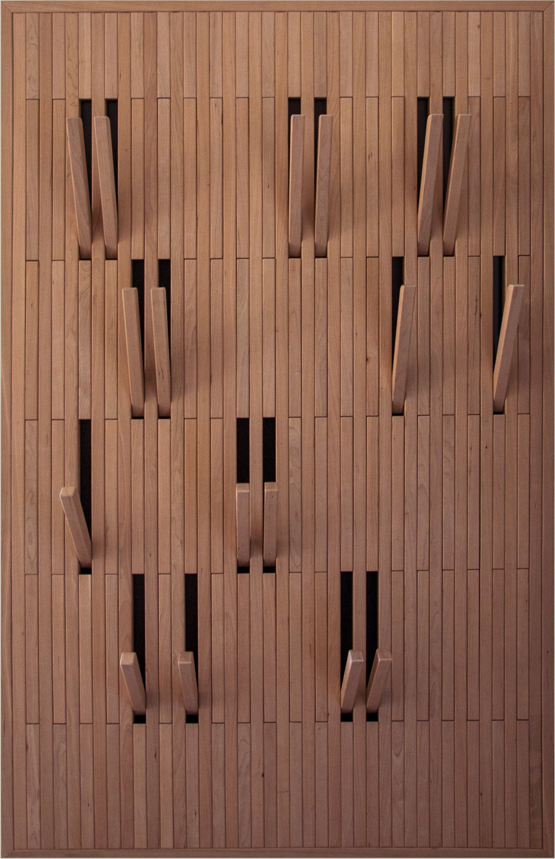 Un appendiabiti da parete in legno con lamelle retrattili che si aprono per fungere da ganci singoli.