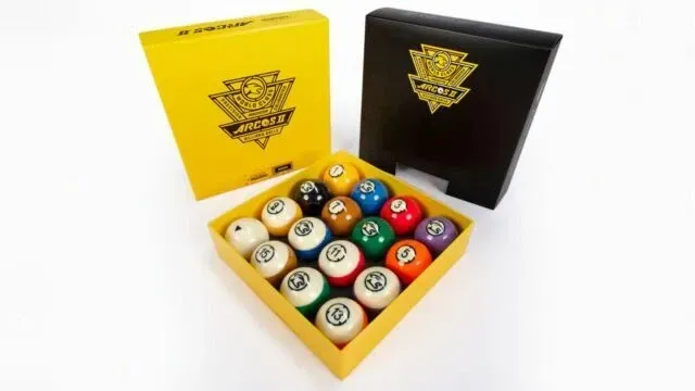 Open box of colorful billiard balls with yellow and black packaging