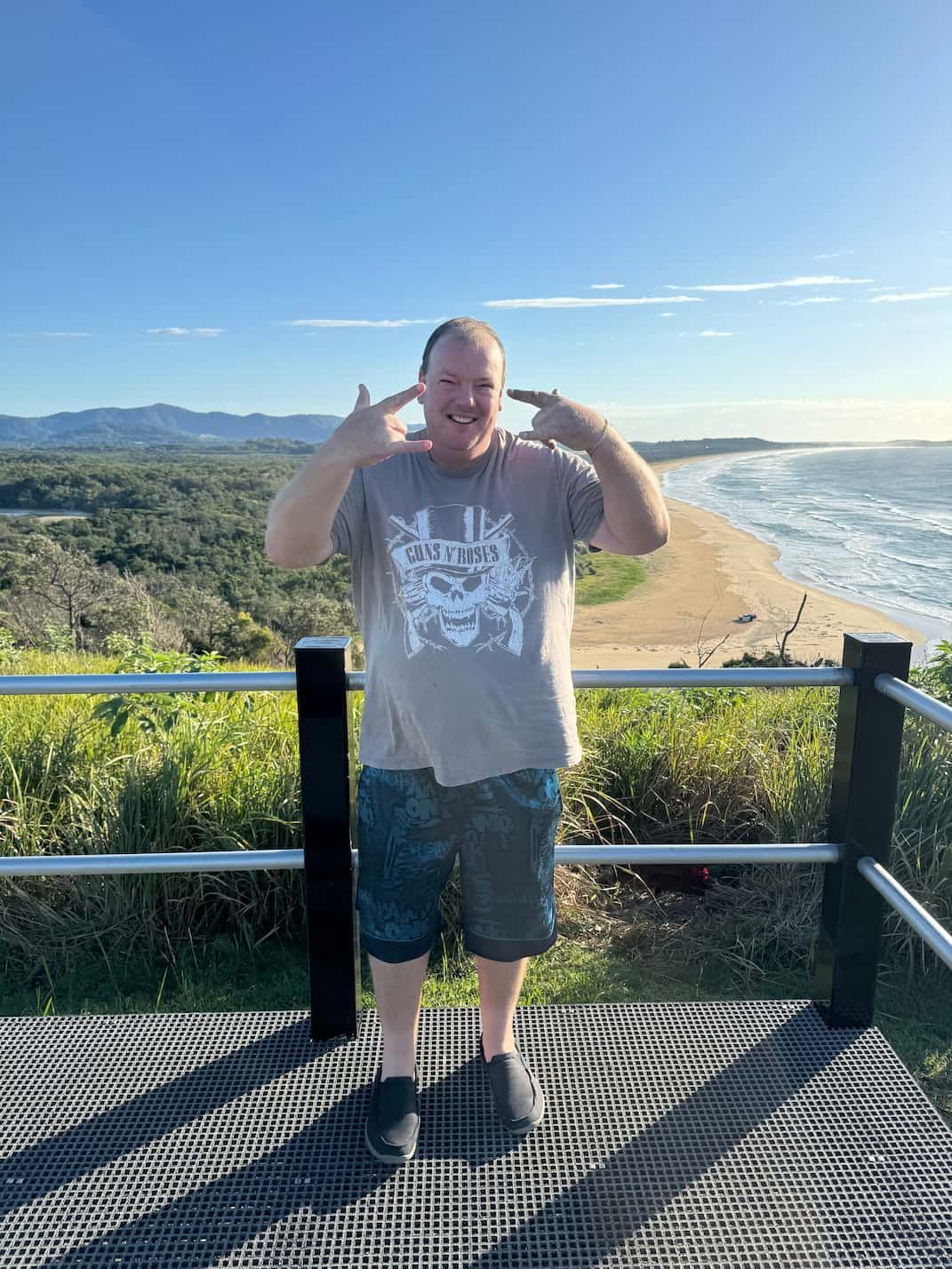 A Man is Standing on a Balcony Overlooking a Beach — Mentally Hooked in Helensvale, QLD