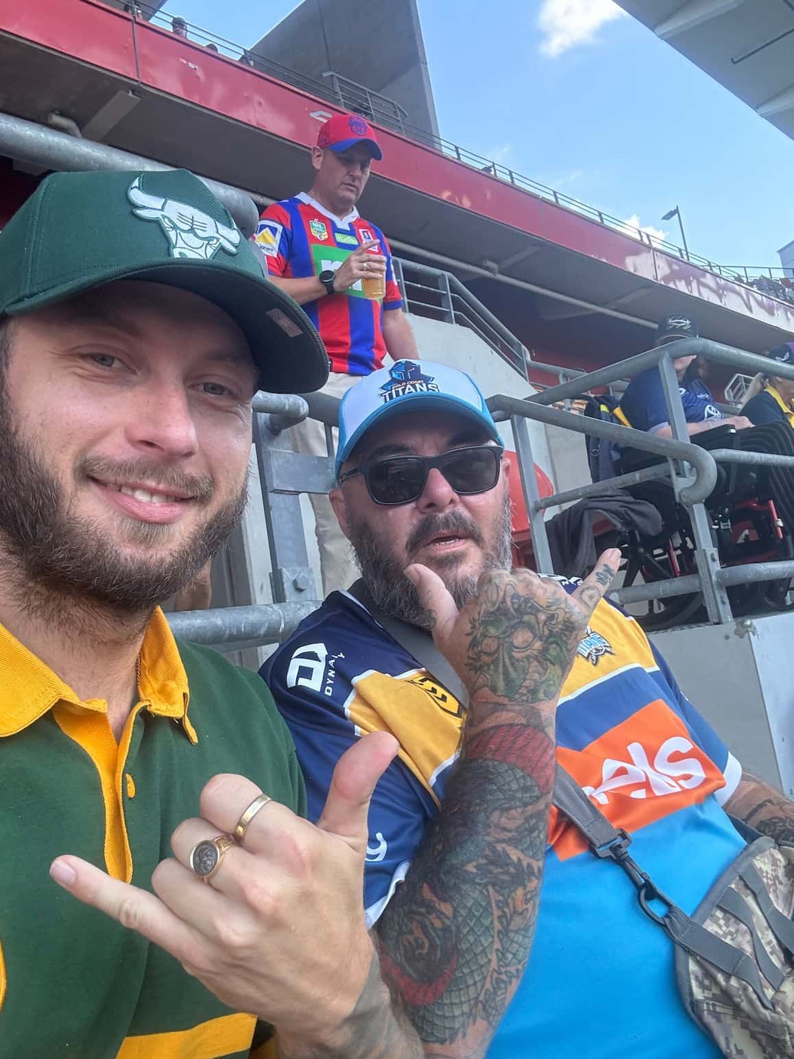 Two Men Are Standing Next to Each Other in a Stadium Giving a Thumbs Up — Mentally Hooked in Helensvale, QLD