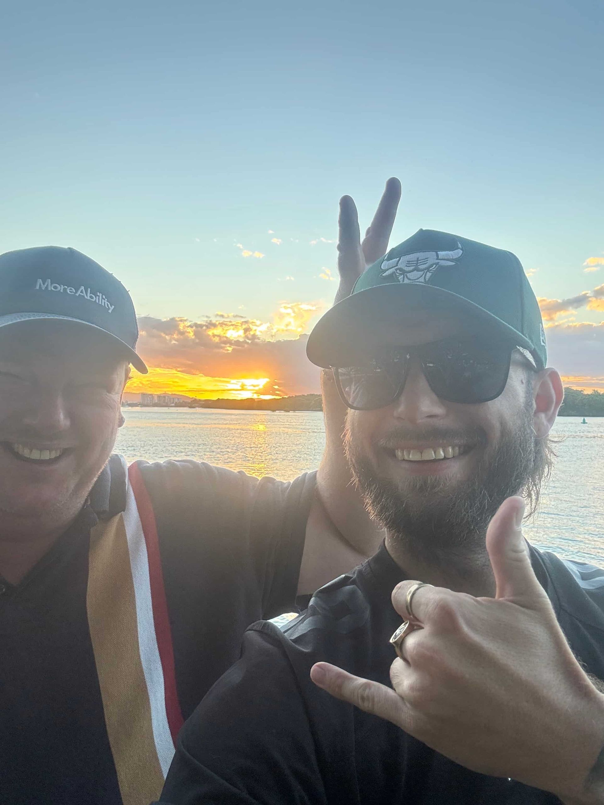 Two Men Are Posing for a Picture in Front of a Body of Water — Mentally Hooked in Helensvale, QLD
