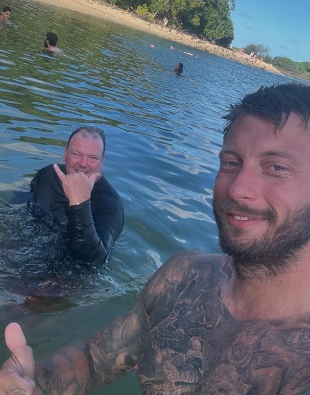 Two Men Are Swimming in a Lake and One of Them is Giving a Thumbs Up — Mentally Hooked in Helensvale, QLD