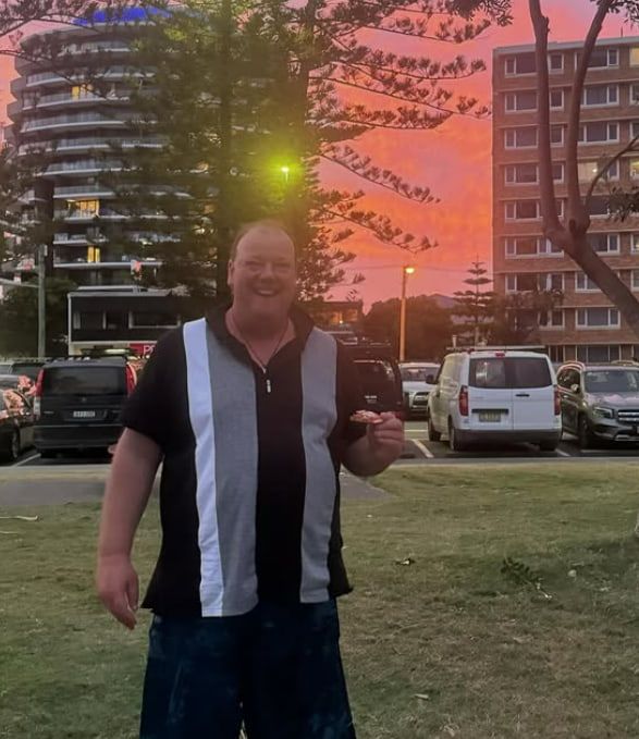 A Man in a Black and White Shirt is Standing in a Parking Lot — Mentally Hooked in Helensvale, QLD
