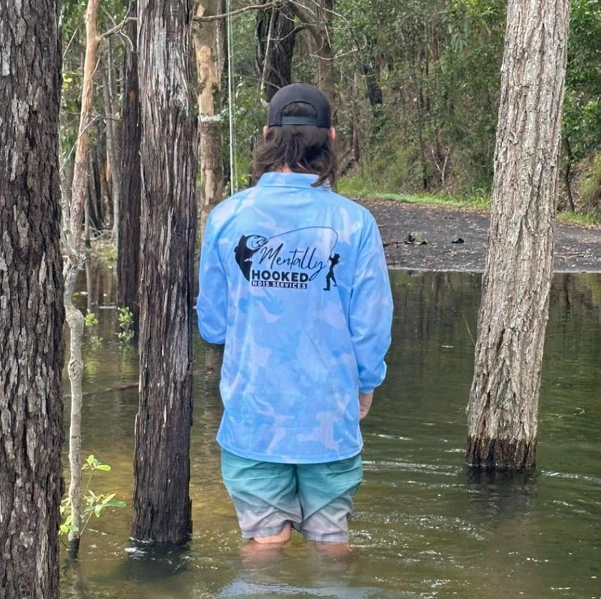 Qlda Man in a Blue Shirt is in the Water — Mentally Hooked in Helensvale, QLD