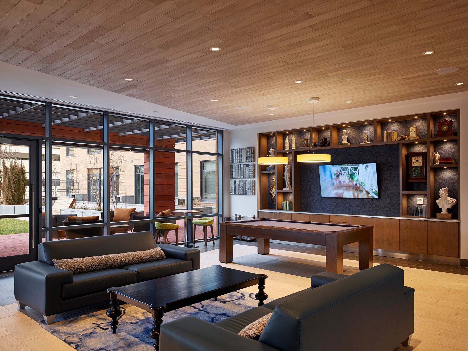 A community lounge area with furniture and a pool table at Solaire 8250 Georgia in Silver Spring, MD.