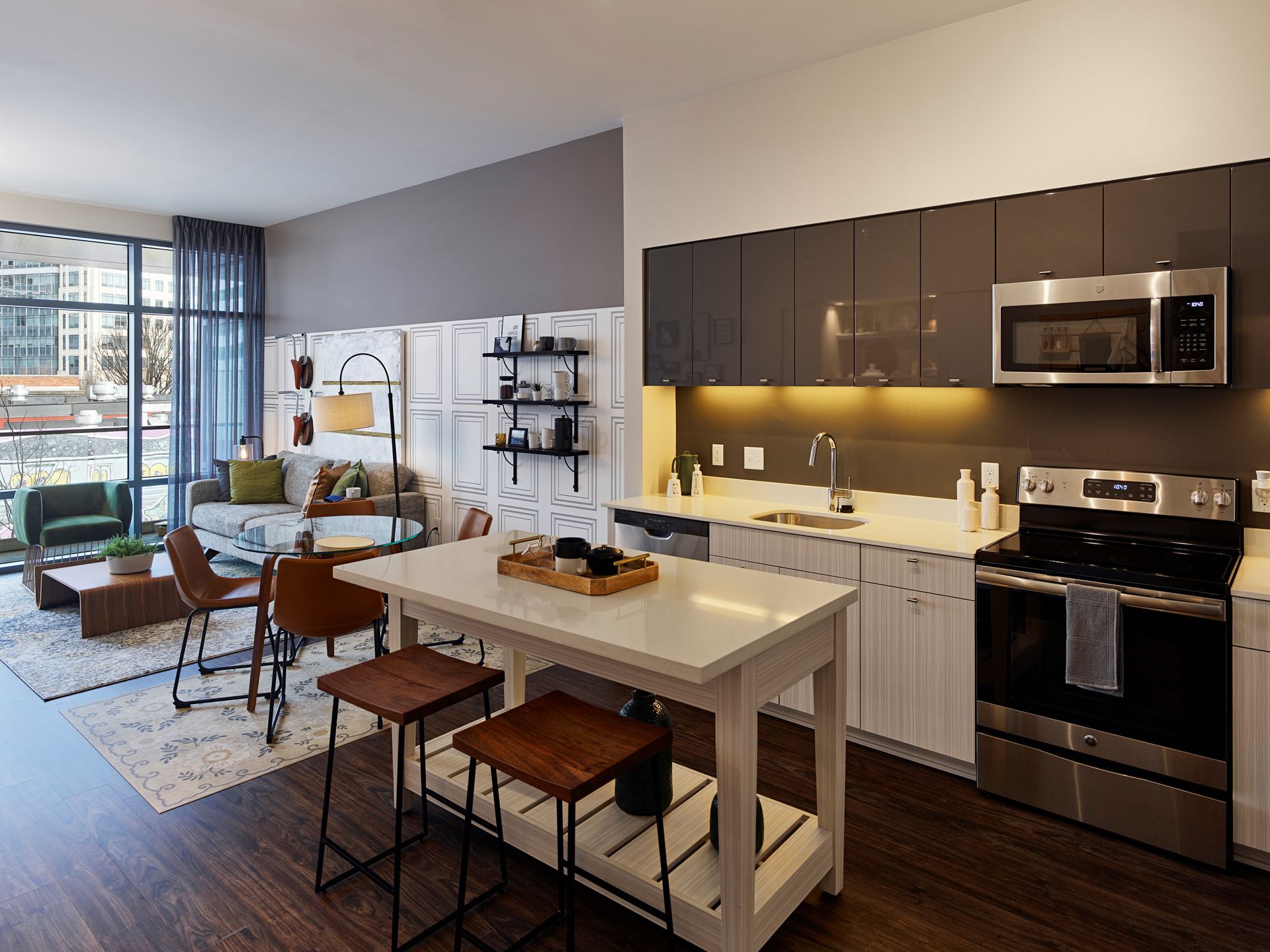 A kitchen with stainless steel appliances and a large island in the middle at Solaire 8250 Georgia in Silver Spring, MD.