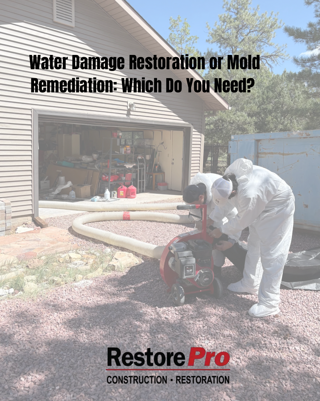 Flood restoration worker in white protective suit using a wet vacuum in a garage, with text about mold remediation.