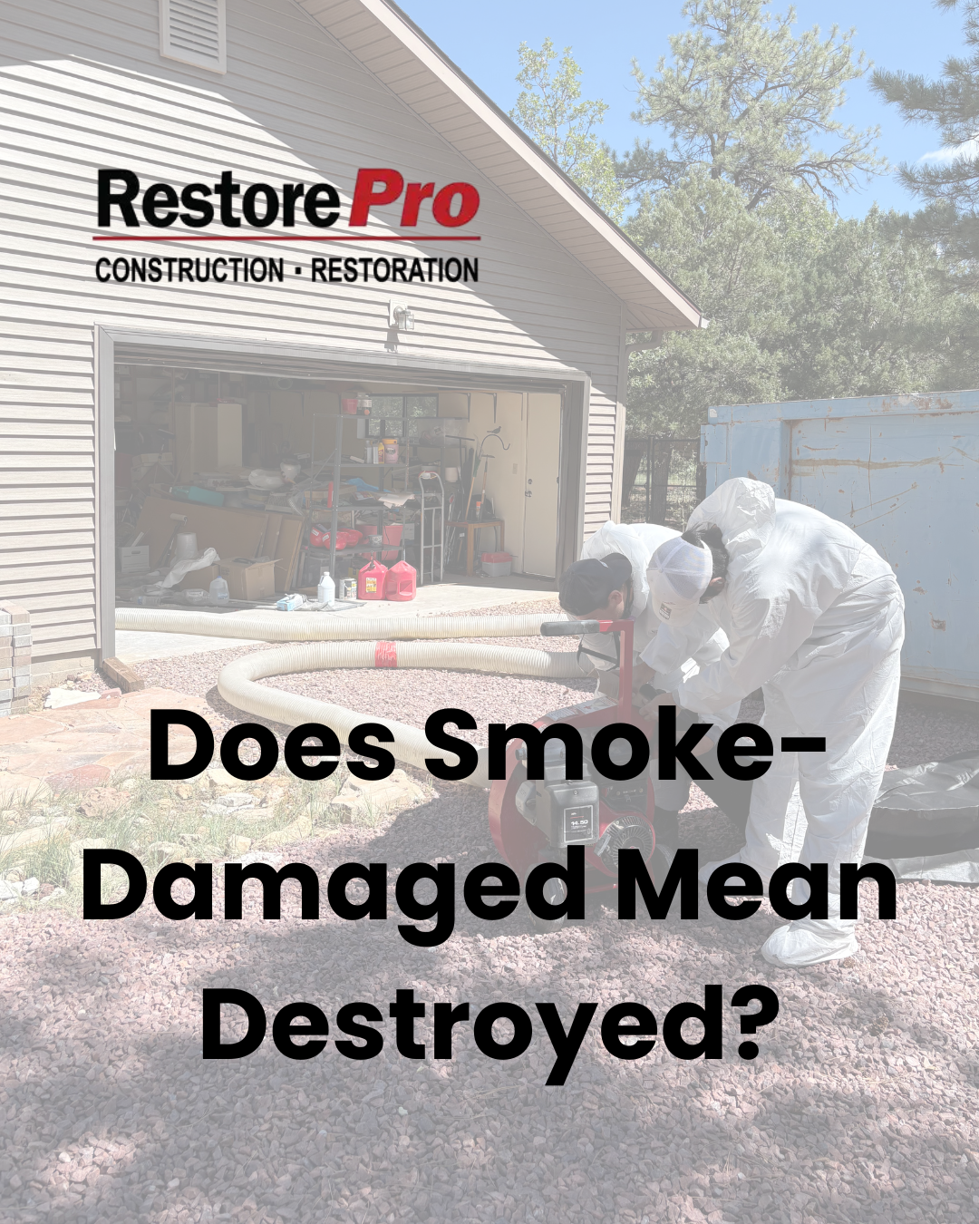 Workers clean a smoke-damaged home exterior with text: “Does Smoke-Damaged Mean Destroyed?”